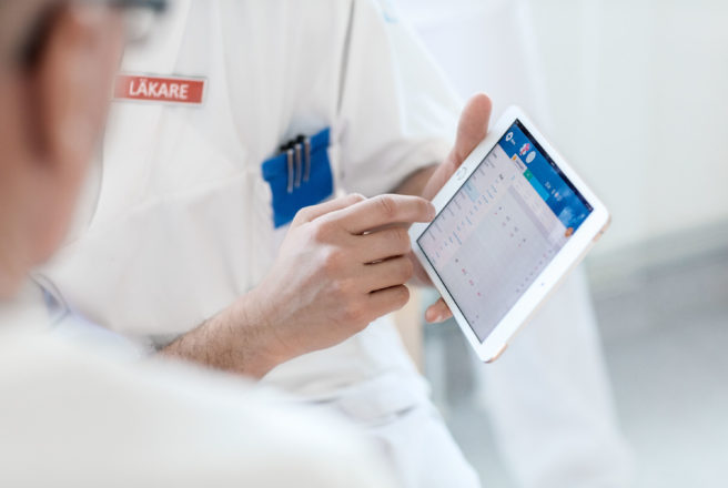 Medical staff pointing at a tablet